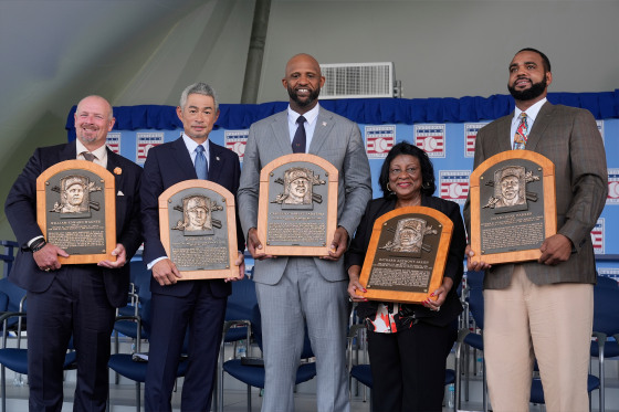 Baseball Hall of Fame inductees Billy Wagner, left, Ichiro Suzuki, second from left, and CC Sabathia, center, pose for a photo with Willa Allen, second from right, widow of Baseball Hall of Fame inductee Dick Allen, and Dave Parker II, right, son of the late Baseball Hall of Fame inductee Dave Parker, at the National Baseball Hall of Fame induction ceremony in Cooperstown, N.Y., Sunday, July 27, 2025.