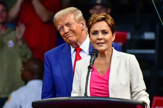 Kari Lake speaks in front of Donald Trump at a rally in Arizona in 2024.