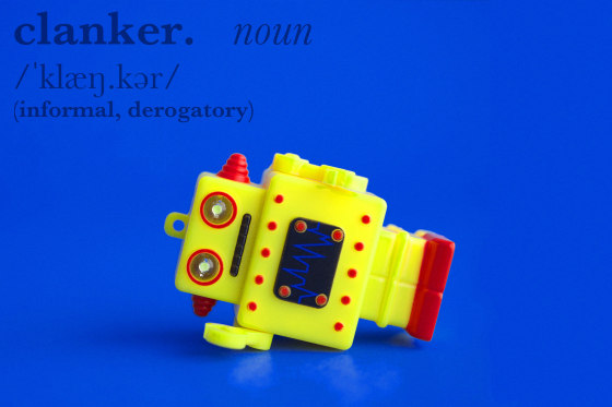 "Clanker" pronunciation and definition, with a robot toy lying on its side.