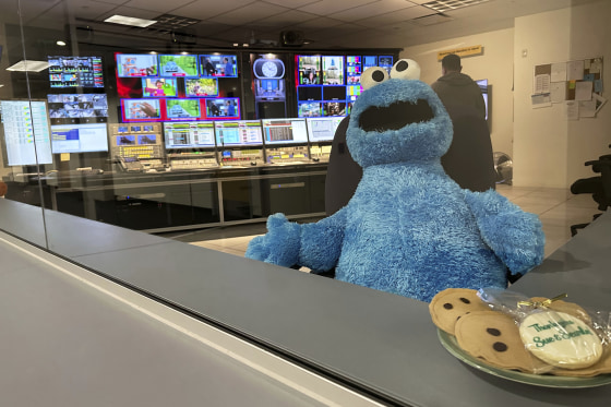 Image: A stuffed Cookie Monster is seated in a control room at the Arizona PBS offices in Phoenix.
