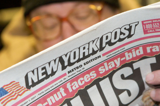 Alan Brown reads the New York Post newspaper while riding th