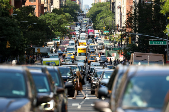 Cars and pedestrians move along the 2nd Avenue in the Manhattan borough of New York City on July 29, 2025. 