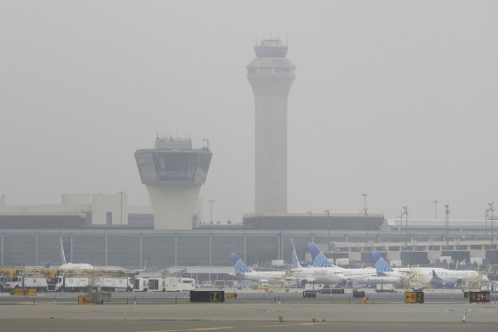 Image: Fog covers planes and control towers at Newark Liberty International Airport in Newark, N.J.