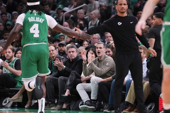  Bill Chisholm, seated right, applauds. 