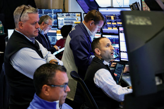 Traders work on the floor of the NYSE in New York