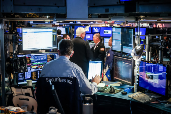 Traders work on the floor at the New York Stock Exchange
