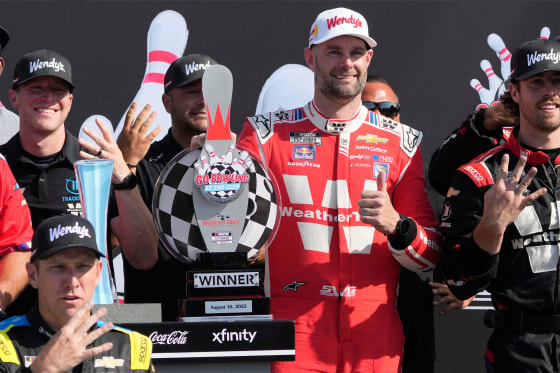 Shane van Gisbergen, center right, poses fort pictures with his team after finishing first during a NASCAR Cup Series auto race in Watkins Glen, N.Y., on Sunday.