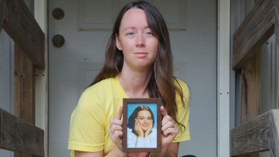 Samantha Rodriguez holding a photo of her sister, Brandi Wells