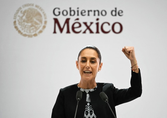Mexico's President Claudia Sheinbaum raises her fist as she delivers her first State of the Nation Address at Palacio Nacional in Mexico City.
