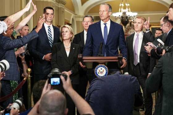 Reporters ask John Thune questions at a news conference.