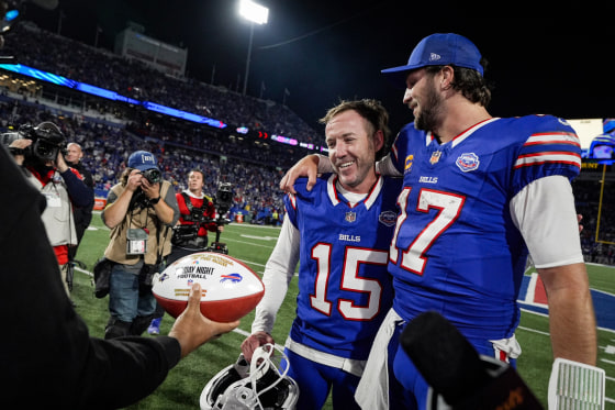 Josh Allen, right, with Matt Prater on the football field speak to reporters
