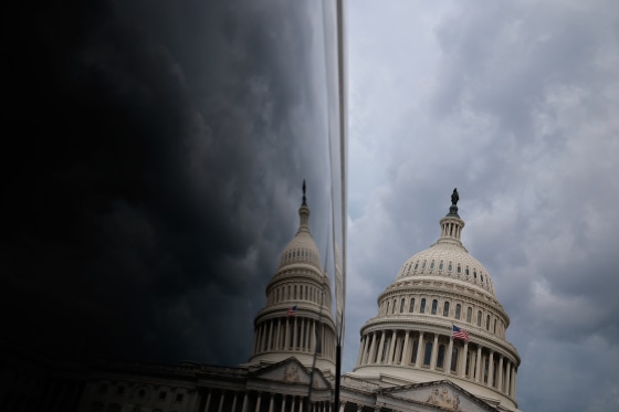 Storm clouds hover over the U.S. Capitol in July 2025.