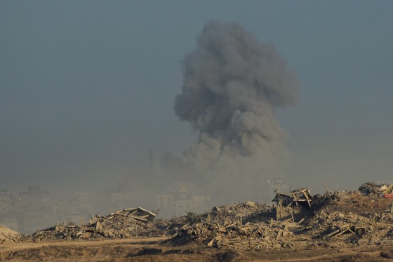 Smoke rises in the air above rubble