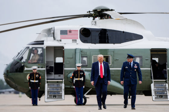 Donald Trump walks on the tarmac in front of the Marine One aircraft