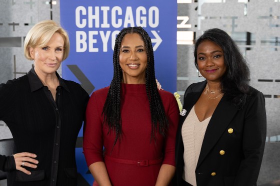 Mika Brzezinski, Liz Dozier, and Tatyana Ali in front of a Chicago Beyond sign.