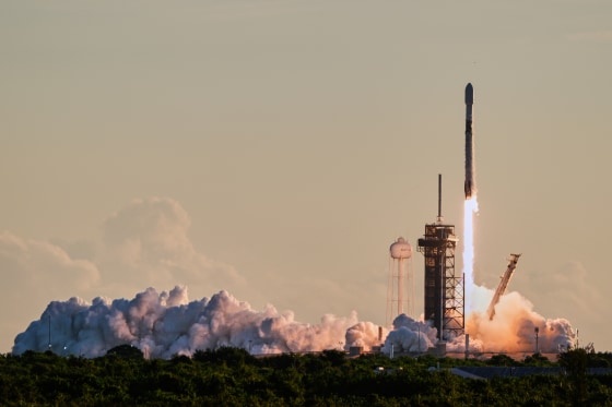 A rocket launches from a launch pad into the sky