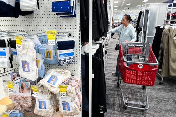 A person with a red Target shopping cart shops inside of Target