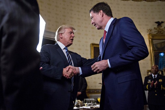 U.S. President Donald Trump shakes hands with James Comey, former director of the FBI in the White House.