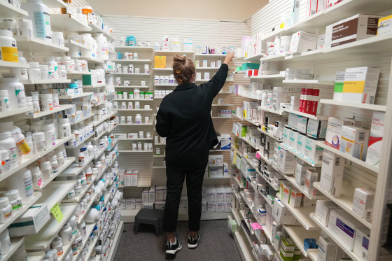 A pharmacy tech looks for a drug on a shelf at a pharmacy in Provo, Utah, on Aug. 7, 2025. 