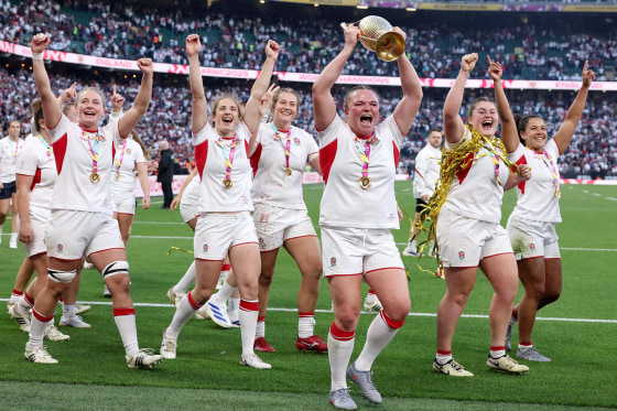England's Sarah Bern lifts the Women's Rugby World Cup Trophy 