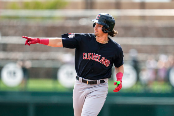Chase DeLauter points while running on the baseball field