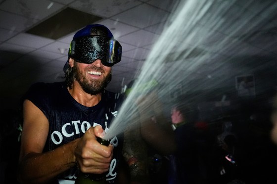 Toronto Blue Jays' Kevin Gausman celebrates with teammates in the clubhouse after their game against the Kansas City Royals, Sunday, Sept. 21, 2025.