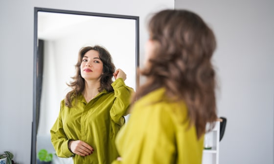 Woman looking at herself in the mirror.