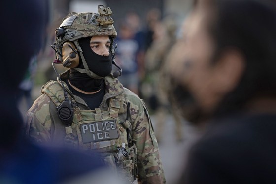 An ICE agent confronts demonstrators protesting outside of an immigrant processing center on Sept. 27, 2025 in Broadview, Ill.
