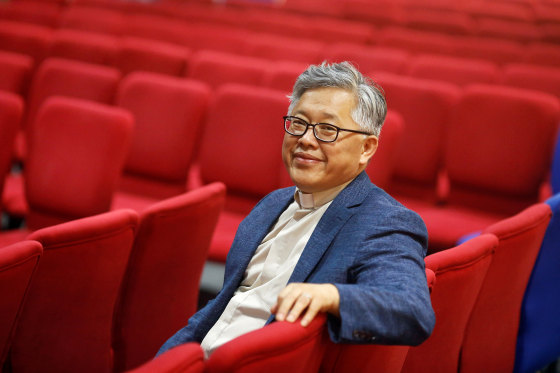 The head pastor of the Zion church in Beijing Jin Mingri poses for picures in the congregation hall of the unofficial Protestant "house" church in Beijing