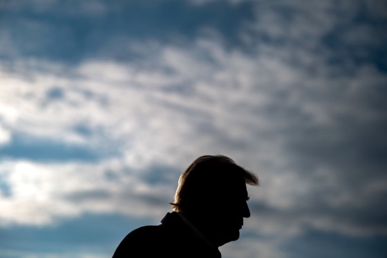 President Donald Trump against a cloudy sky.