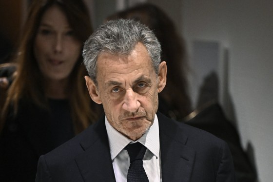 Former French president Nicolas Sarkozy leaves ahead of his wife, French-Italian singer Carla Bruni, after the verdict in his trial in Paris, on Sept. 25, 2025.