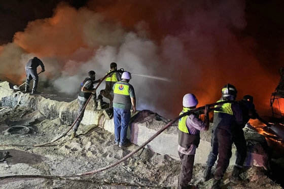 Firefighters battle blazes following a series of Israeli strikes in Ansar, southern Lebanon, on Oct. 16, 2025.
