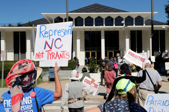 Demonstrators approach the Legislative Building during a rally protesting a proposed election redistricting map Tuesday, Oct. 21, 2025, in Raleigh, N.C.