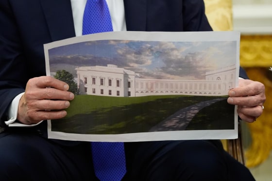 President Donald Trump holds an artist's rendering of the new White House ballroom on Oct. 22, 2025.