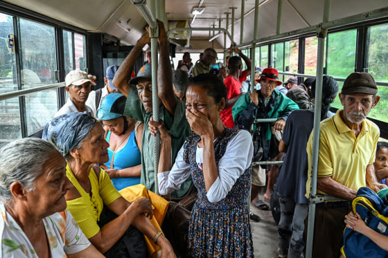 A woman reacts on the bus as residents are evacuated to safe locations ahead of the arrival of Hurricane Melissa.