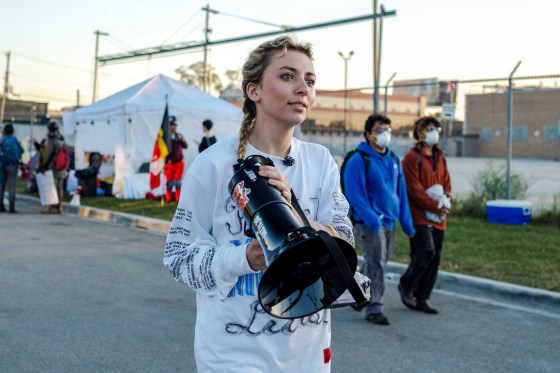 Kat Abughazaleh holds a megaphone outside of the Broadview ICE processing facility.