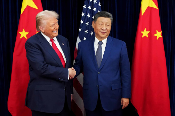 President Donald Trump greets Chinese President Xi Jinping ahead of a bilateral meeting at Gimhae Air Base on Thursday.