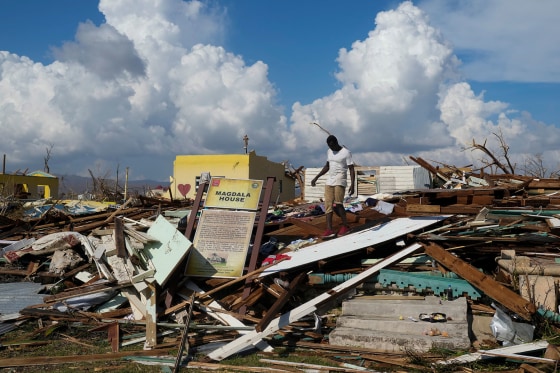 A man looks for salvageable items in the aftermath of Hurricane Melissa in Black River, Jamaica, Thursday, Oct. 30, 2025.