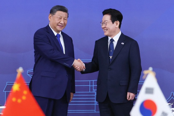 China's President Xi Jinping and South Korea's President Lee Jae Myung shake hands on Nov. 1, 2025.