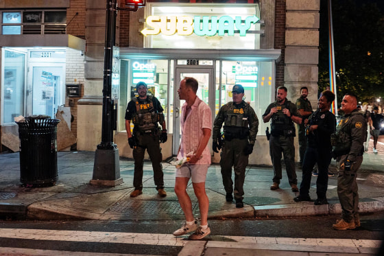 FBI and Border Patrol officers speak with Sean Charles Dunn along the U Street corridor on Aug. 10, 2025 in Washington, D.C.