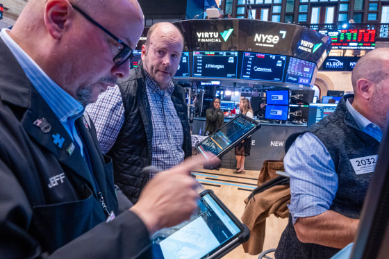 Traders work on the floor.