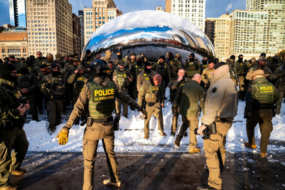 Border Patrol agents pose at The Bean in Chicago