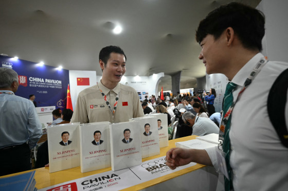 A visitor looks at Xi Jinping's book at China's Pavillion during the COP30 UN Climate Change Conference in Belem, Brazil on Nov. 10.