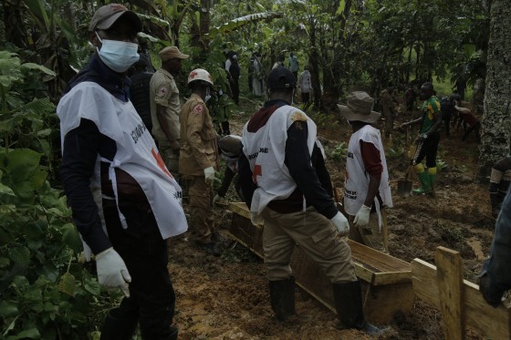 Democratic Republic of Congo Red Cross volunteers gather around coffins containing the remains of victims of an attack during a burial ceremony in Ntoyo, on September 10. 