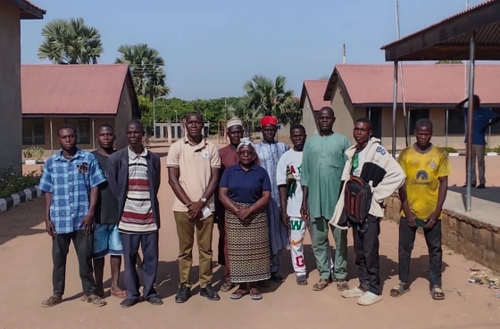 Community members pose for a photograph at St. Mary's Catholic Primary and Secondary School after gunmen abducted children and staff in the Papiri community in Nigeria on Friday.