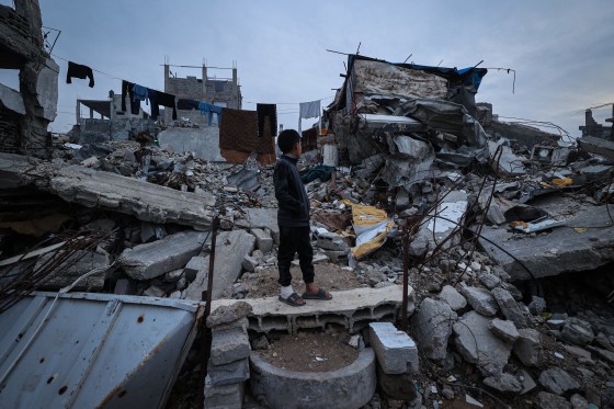 A displaced Palestinian boy stands on the ruins of destroyed buildings in the Bureij refugee camp in the central Gaza Strip on Saturday.