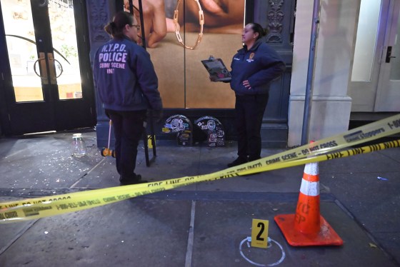 Members of the NYPD Crime Scene Unit investigate the scene after a robbery at 4Gseller in New York