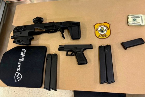 During their investigation, Officers discovered the following items in his vehicle:
• Loaded Glock .357 handgun
• Micro Conversion Kit for a Glock handgun
• Four loaded 27-round extended magazines
• Ballistic hard plate (body armor) • Binoculars, Laptop, Composition Notebook