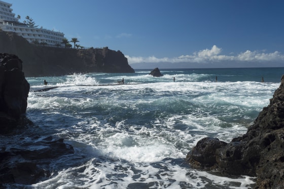 View of natural rock swimming pool Charco de Isla Cangrejo in the Atlantic Ocean in Los Gigantes, Tenerife, Canary islands, Spain.