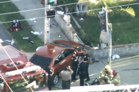 A still from video recorded by NBC Los Angeles shows a car on the sidewalk after it crashed into the perimeter wall of a home.